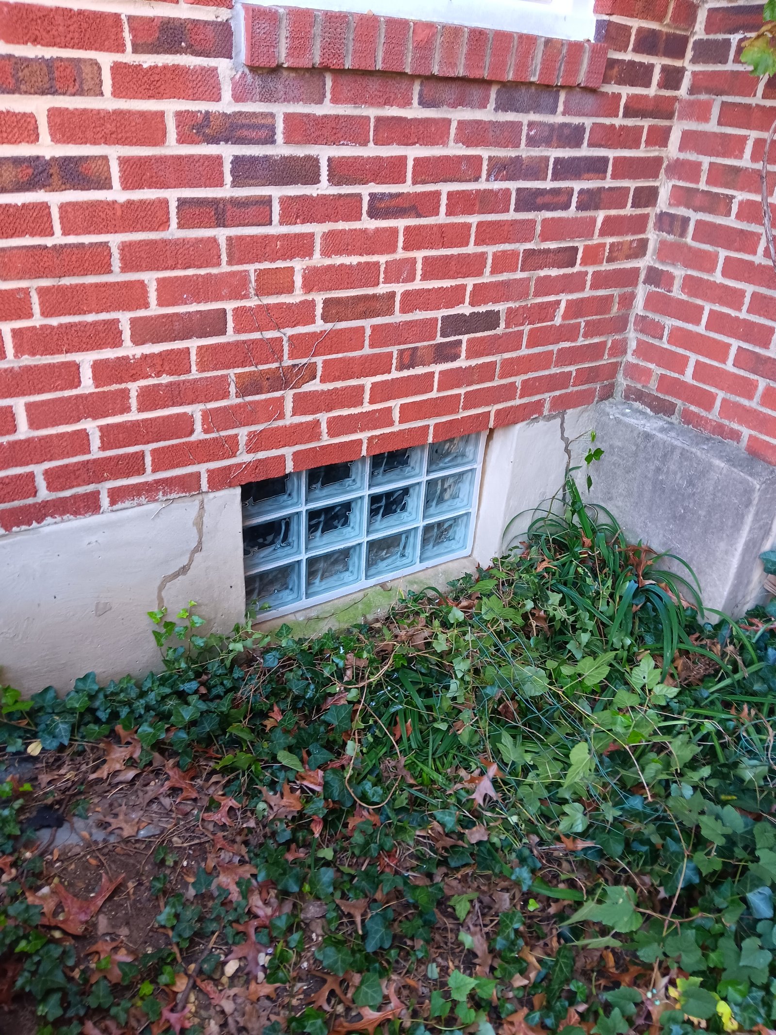 Glass block basement window in brick foundation