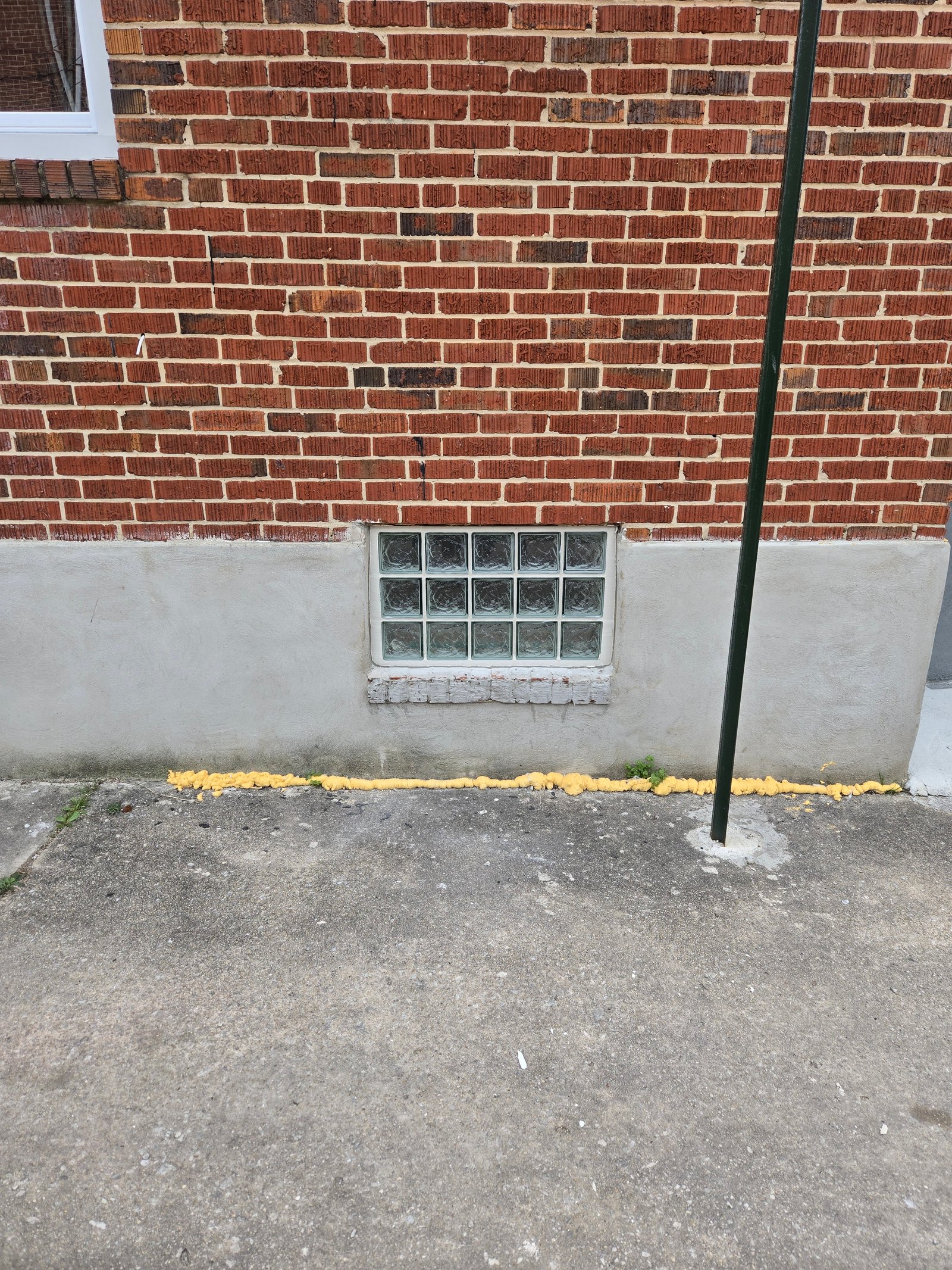 Glass block window in concrete foundation